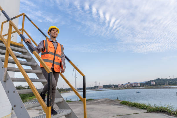 istock An Asian female wind power worker used a computer to check problems in the wind turbine 1397818504