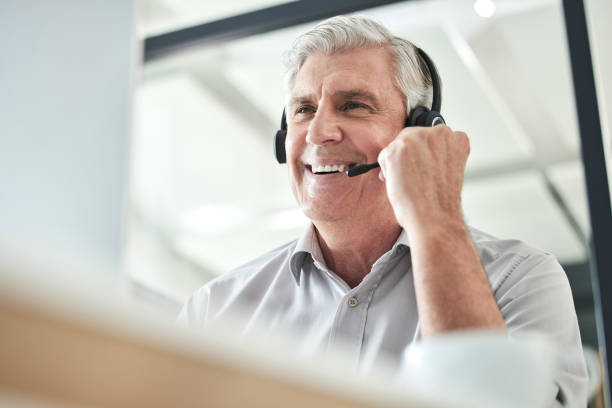 istock Shot of a mature call centre agent sitting alone in the office and using his computer 1397818642
