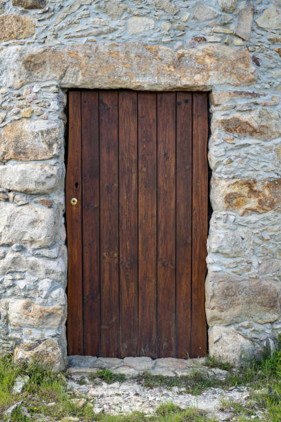 istock Old wooden door and stone wall 1397819445