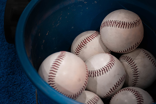 Baseball balls on the synthetic mat of a sports gym.