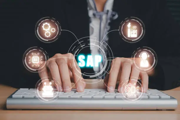 Photo of SAP - Business process automation software and management software (SAP), Person hand typing on keyboard with ERP enterprise resources planning system concept on virtual screen.