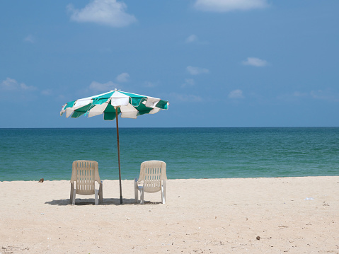 Beach on the island with beach chairs and umbrella in summer season of Thailand.