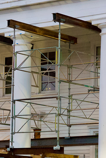 Fairfax, Virginia, USA - May 16, 2022: Scaffolding and steel beams support the roof of the historic “Old Town Hall” during restoration efforts.