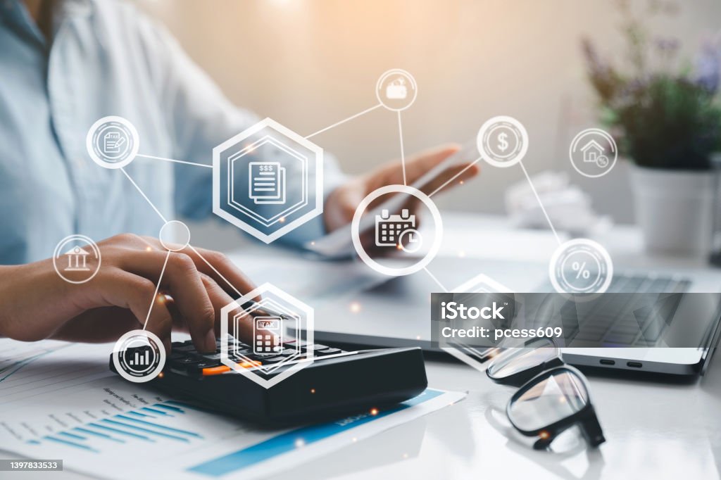 Man hand using a calculator and fill in the income tax online return form for payment. Financial research, government taxes, and calculation tax return concept.Tax and Vat concept. Finance Stock Photo