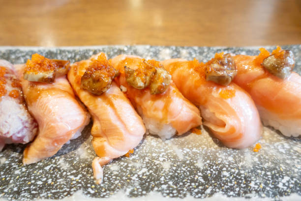 grilled salmon sushi salmon aburi sushi with foie gras - fine dining grilled spring onion healthy lifestyle imagens e fotografias de stock