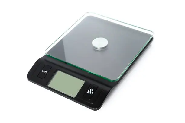 Digital kitchen scale, top angle view, on white background.