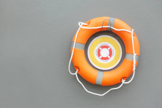 istock Lifebuoy on wall background. Help, rescue concept. Copy space. 1397833605