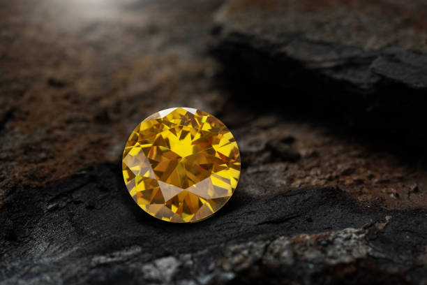 Yellow gemstone on stone background, close up shot