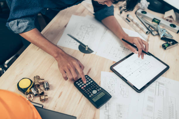istock Architect engineer use calculator for calculate drawing design working on blueprint. House planning design and construction concept. 1397835682