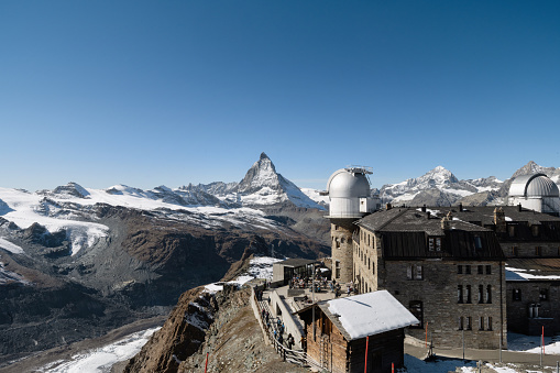 Gornergrat – Switzerland – Oktober 14, 2021  : Europe highest Telescope Station on Gornergrat peak in the Swiss alps with view to famous Matterhorn Mountain