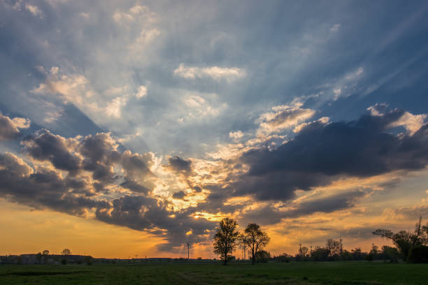 istock Beautiful spring sunrise with dramatic sky and windmils silhouetted on the horizon 1397836467