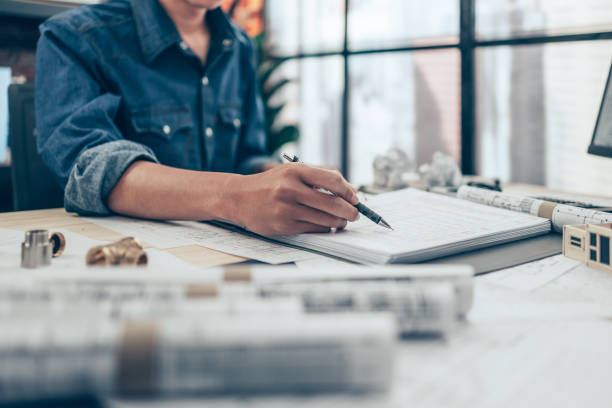 istock Architect engineer use pen  drawing design working on blueprint. House planning design and construction concept. 1397838627