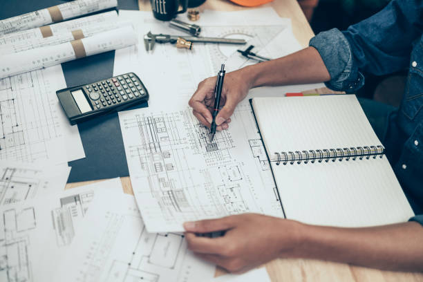 istock Architect engineer use pen  drawing design working on blueprint. House planning design and construction concept. 1397838994
