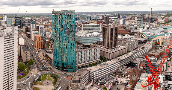 Birmingham, UK - May 10, 2022.  An aerial view of Birmingham cityscape skyline with The Radisson Blu hotel skyscraper in the foreground an New Street train station