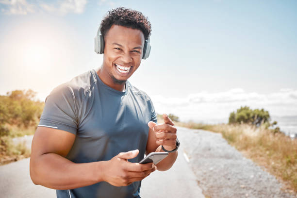 istock Shot of a young man standing and using his phone outside 1397841662