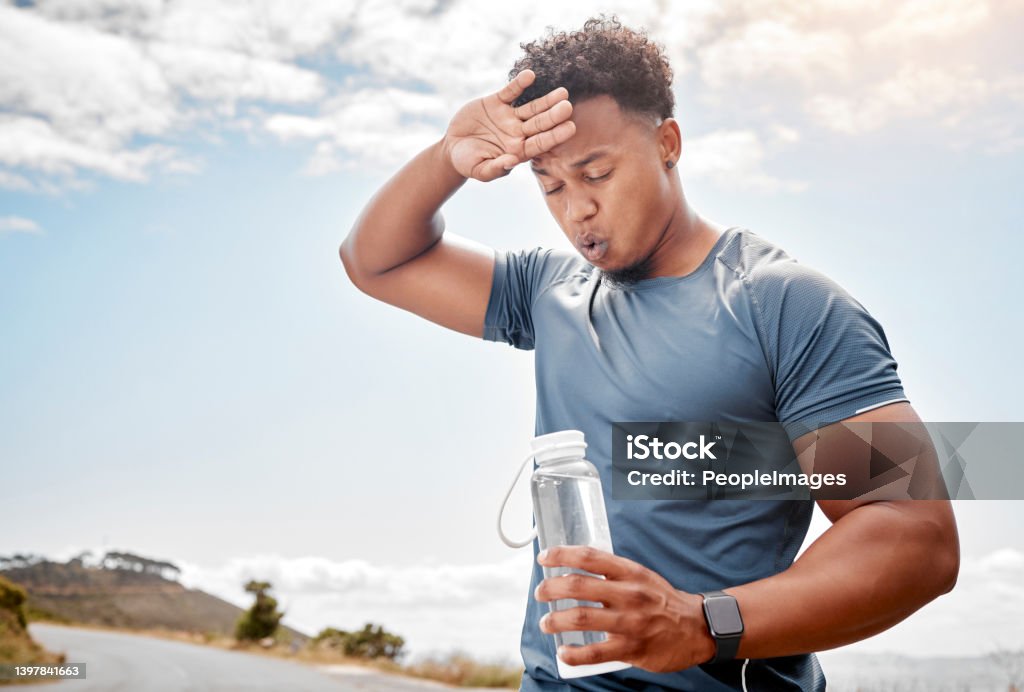 Shot of a man drinking water while out for a workout A healthy outside starts from the inside Sweat Stock Photo