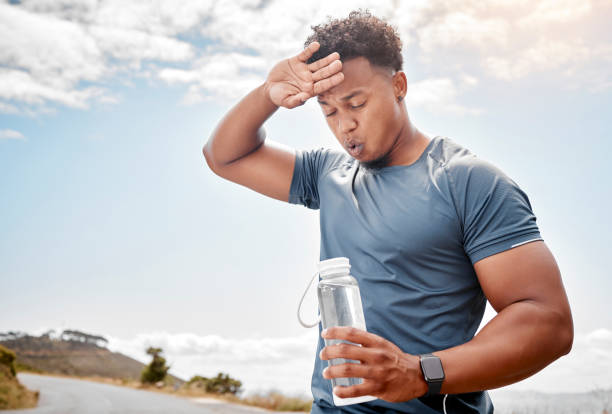 Shot of a man drinking water while out for a workout A healthy outside starts from the inside carpet runner stock pictures, royalty-free photos & images