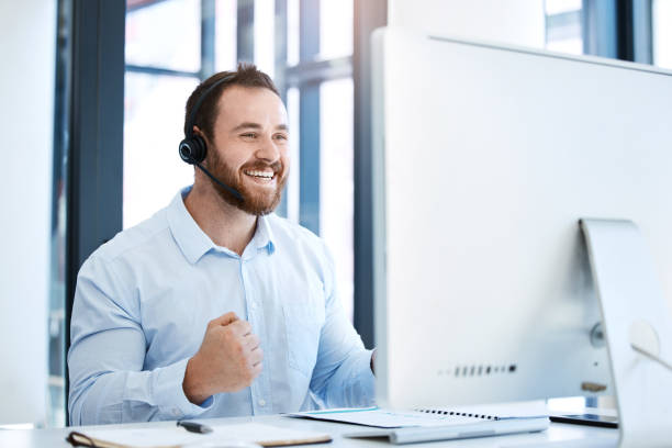 istock Shot of a young call centre agent cheering while working on a computer in an office 1397842816