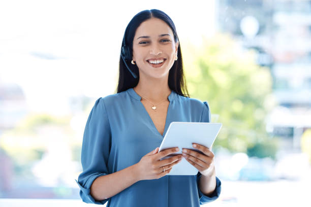 istock Portrait of a young call centre agent working on a digital tablet in an office 1397842836