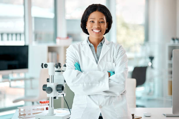 Portrait of a young scientist standing with her arms crossed in a lab Determined to gain results medical physicist stock pictures, royalty-free photos & images