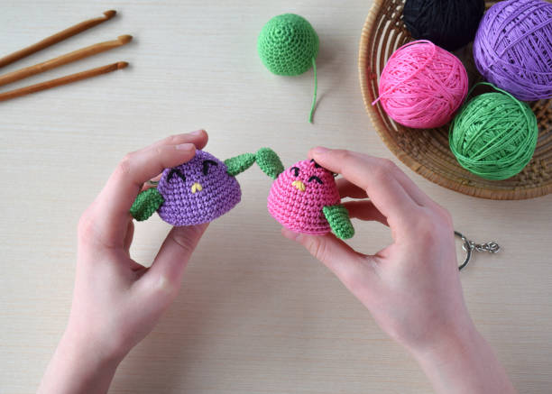 istock Making colored crochet bird. Toy for babies or trinket.  On the table threads, needles, hook, cotton yarn. Handmade gift. DIY crafts concept. 1397844831