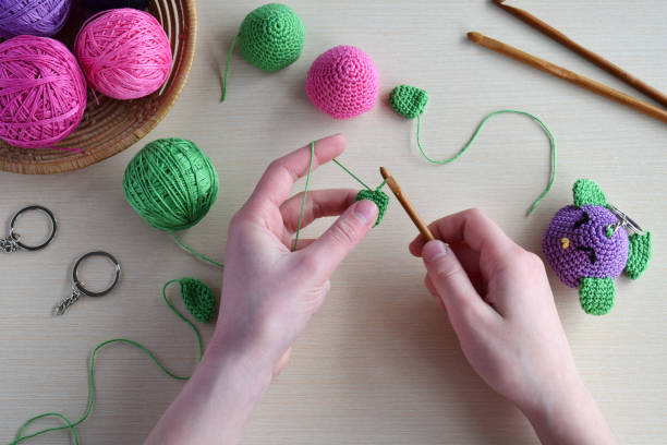 istock Making colored crochet bird. Toy for babies or trinket.  On the table threads, needles, hook, cotton yarn. Handmade gift. DIY crafts concept. 1397844864