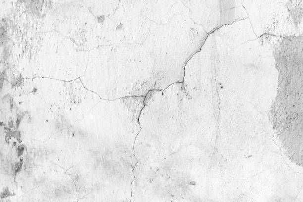 istock Old white concrete wall with cracks and peeling paint, close up 1397847168