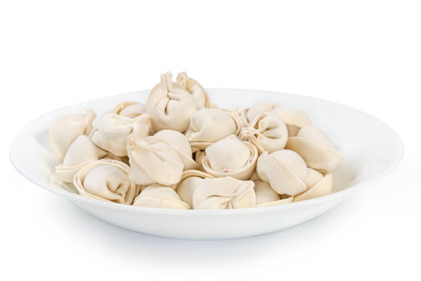 istock Side view of white dish with uncooked frozen meat dumplings 1397848071