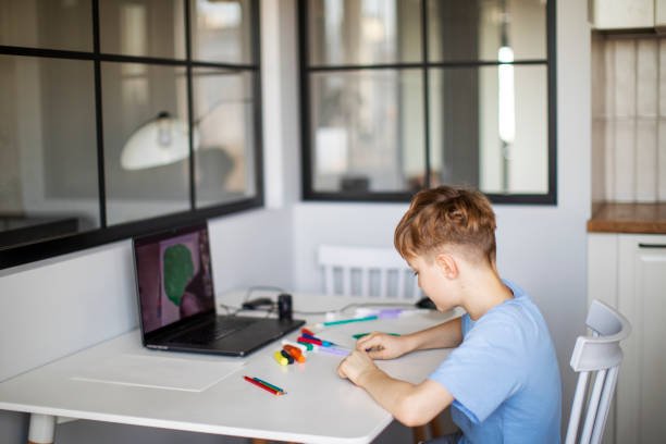 istock Preschool Boy Having Craft Lesson With Clay At Home Using Laptop 1397849924