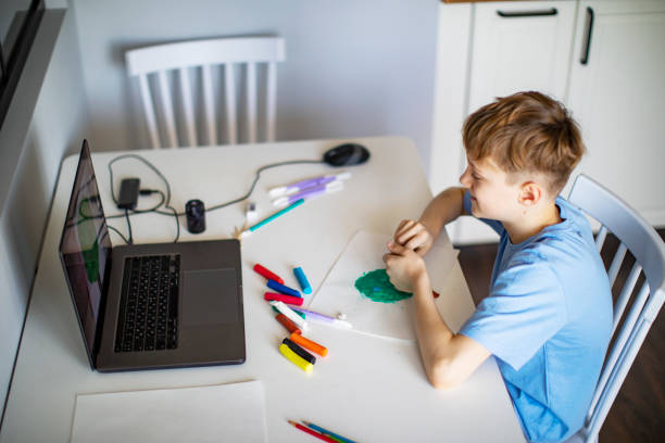 istock Preschool Boy Having Craft Lesson With Clay At Home Using Laptop 1397849944