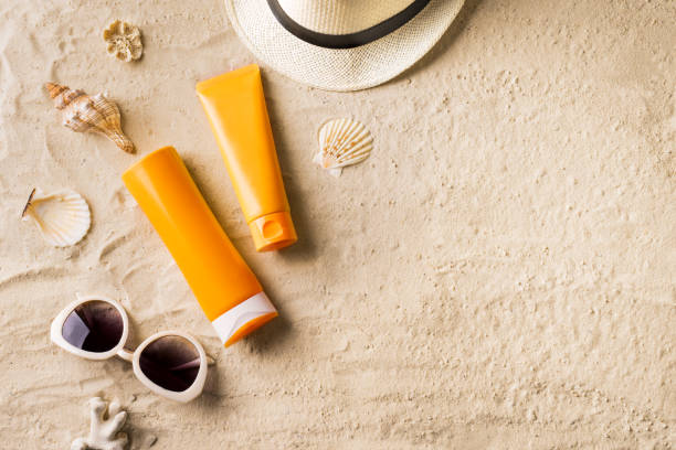 istock Sunblock, sunglasses and hat on summer sandy beach 1397851074