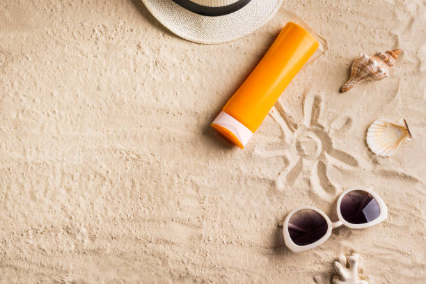 istock Sunscreen sunblock lotion on sandy beach 1397851076