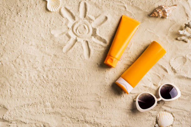 istock Sunscreen lotion on sandy beach 1397851109
