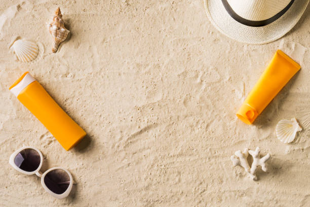 istock Sunblock, sunglasses and hat on summer sandy beach 1397851114