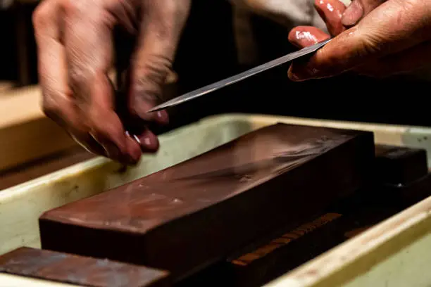 Photo of Swordsmith is checking sharpness of blade of small katana