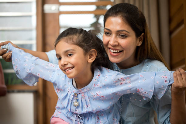 istock Happy mother and daughter having fun at home 1397855512