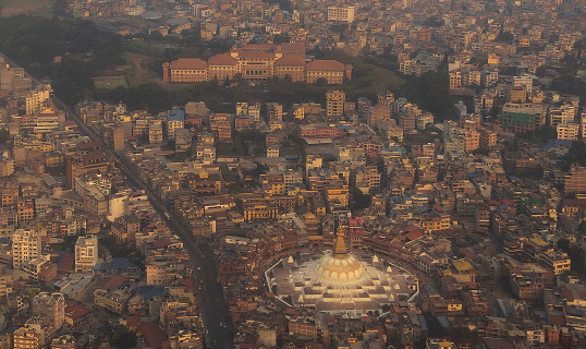 Aerial view of Kathmandu. Boudhanath (or Bodnath) Stupa, a huge, dome topped Buddhist temple stands out of the buildings, Nepal