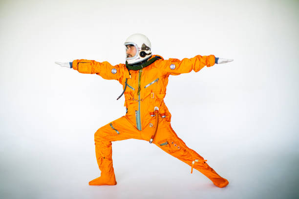 istock Young Man In Space Suit Practising Yoga 1397855931