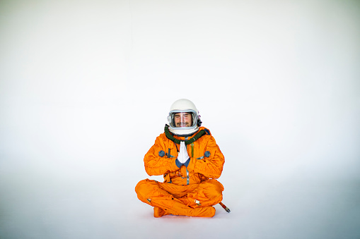 Young Man In Space Suit Practising Yoga