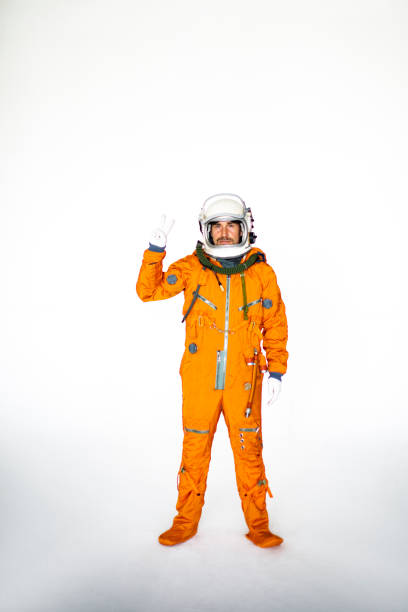 istock Young Man In Space Suit Showing Two Fingers 1397855993