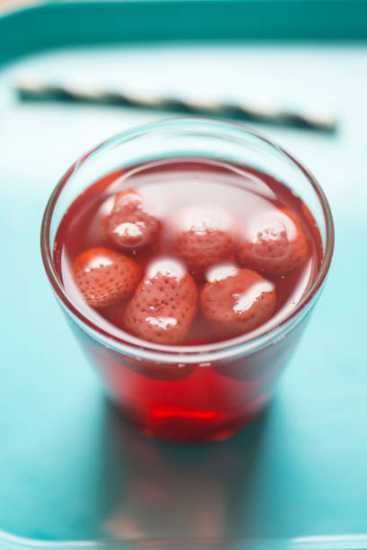 Closeups of glass with lemon-lime-cherry fruity drink.  Garnished with cherries and lime slices with selective focus technique used.  Captured as a 14-bit Raw file. Edited in 16-bit ProPhoto RGB color space.