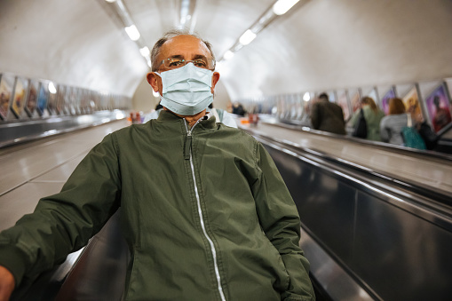 Senior man wearing face in London Tube