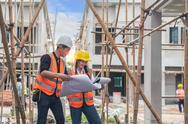 istock Construction concept of Engineer and Architect working at Construction Site with blue print, Engineer foreman discussion work control to building construction working in site. 1397858281