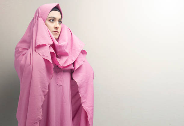 istock Asian Muslim woman in veil in praying position (salat) 1397859607