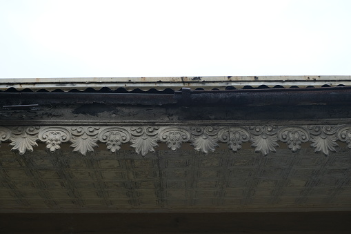 Decorated and engraved gutter of vintage house