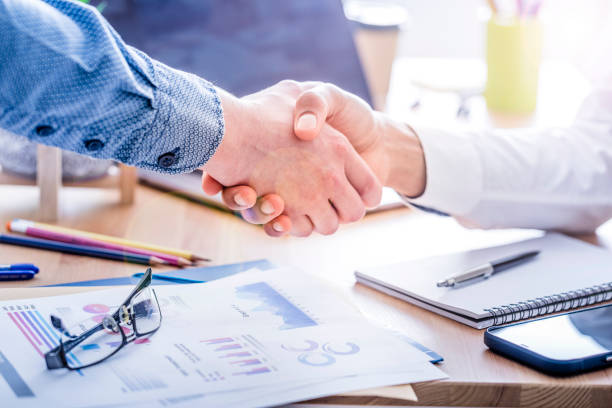Handshake of two businessmen in the office stock photo