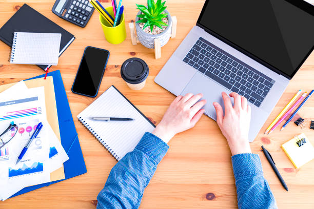istock Businessman hands using laptop at office desk 1397860787