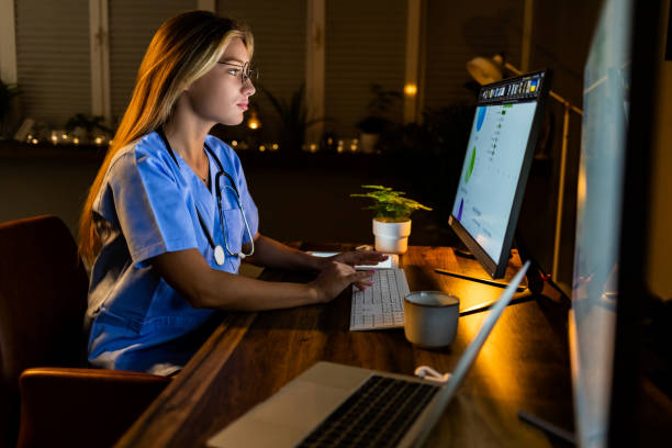 istock Serious Female healthcare worker using computer at office at night. 1397860957