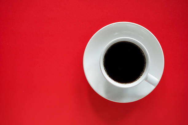 istock Cup of black coffee on red background  with copy space 1397863756