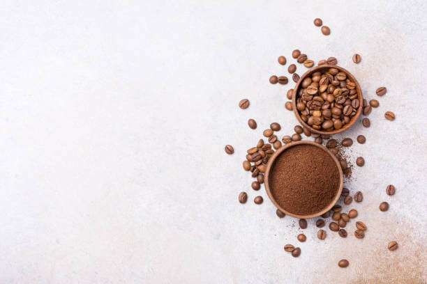 istock Roasted beans with ground coffee in bowls 1397864845